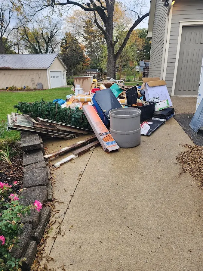 Dumpster being loaded with debris for 30 Yard Dumpster Rental in Glen Cove